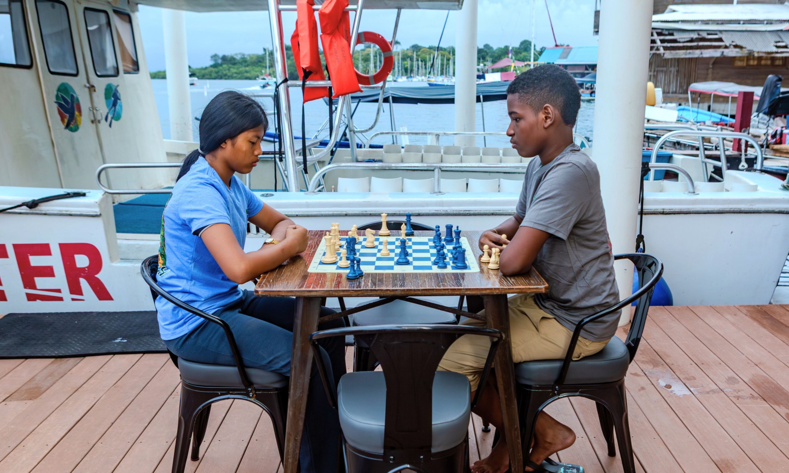 Young members of the Bocas Chess Club playing chess at Divers Paradise Boutique Hotel